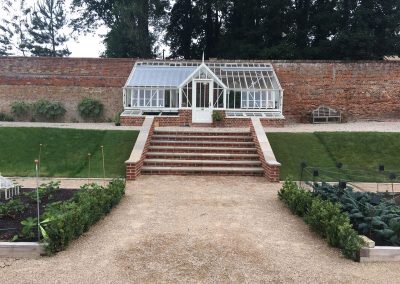 Steps to Greenhouse in large victorian country garden