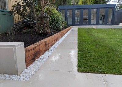 Porcelain path leading to outdoor office with raised bed