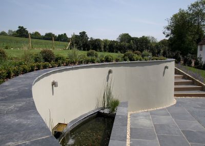 A curved retaining wall in a rural garden